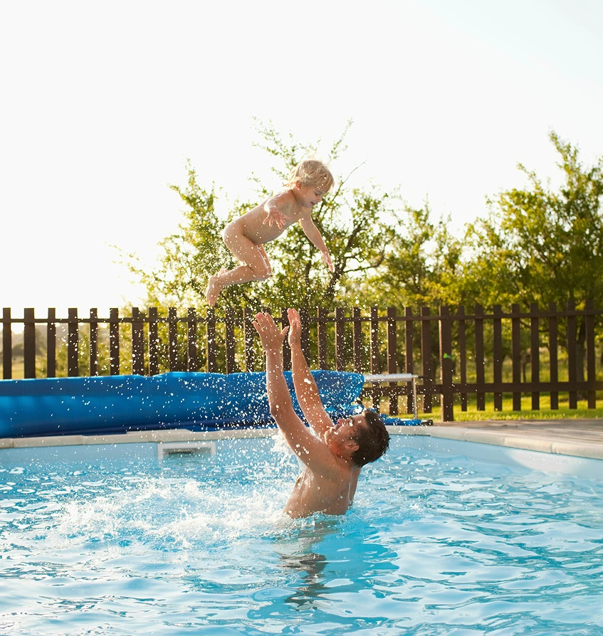 father and kid playing in the pool