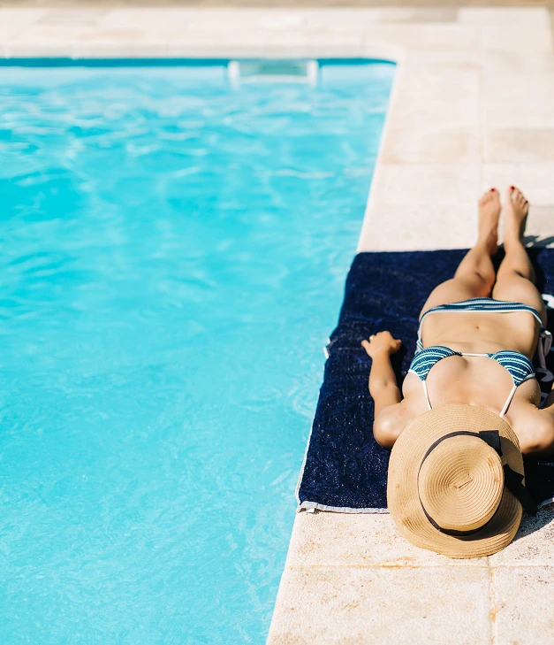 lady tanning beside pool