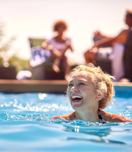 middle aged woman enjoying the pool