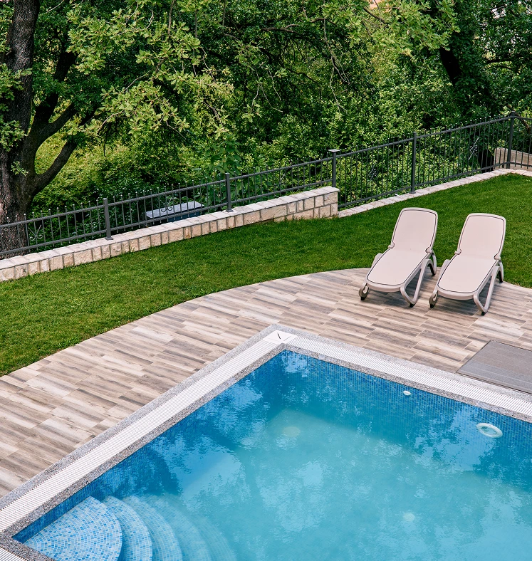 residential pool with deck chairs