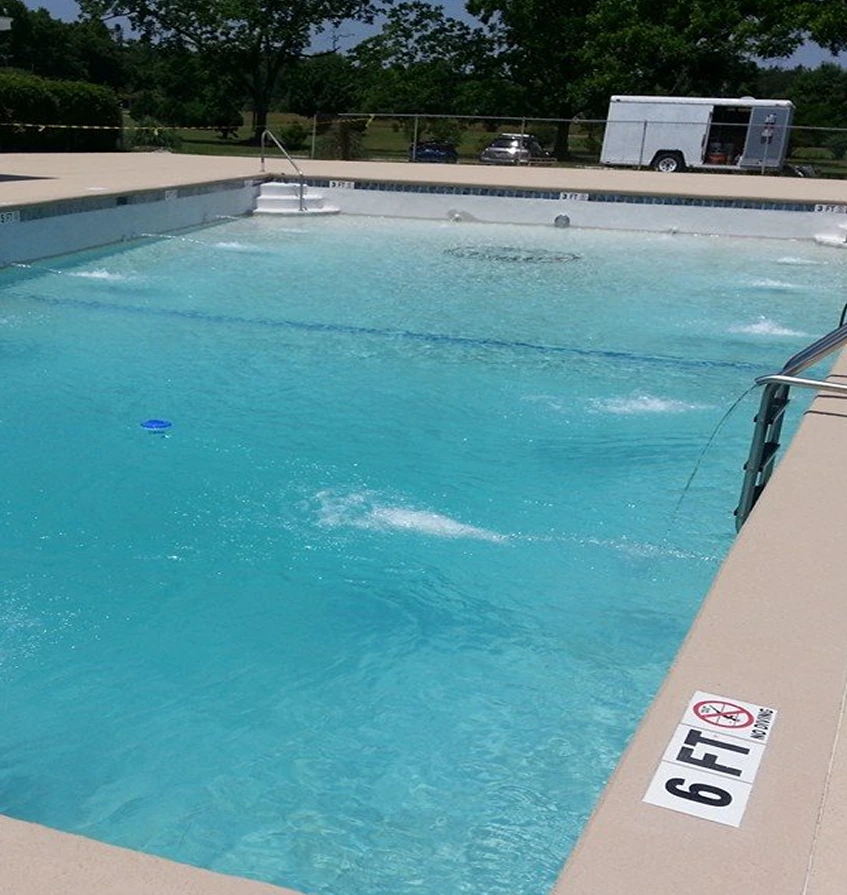 Commercial swimming pool renovation with new resurfacing and water features